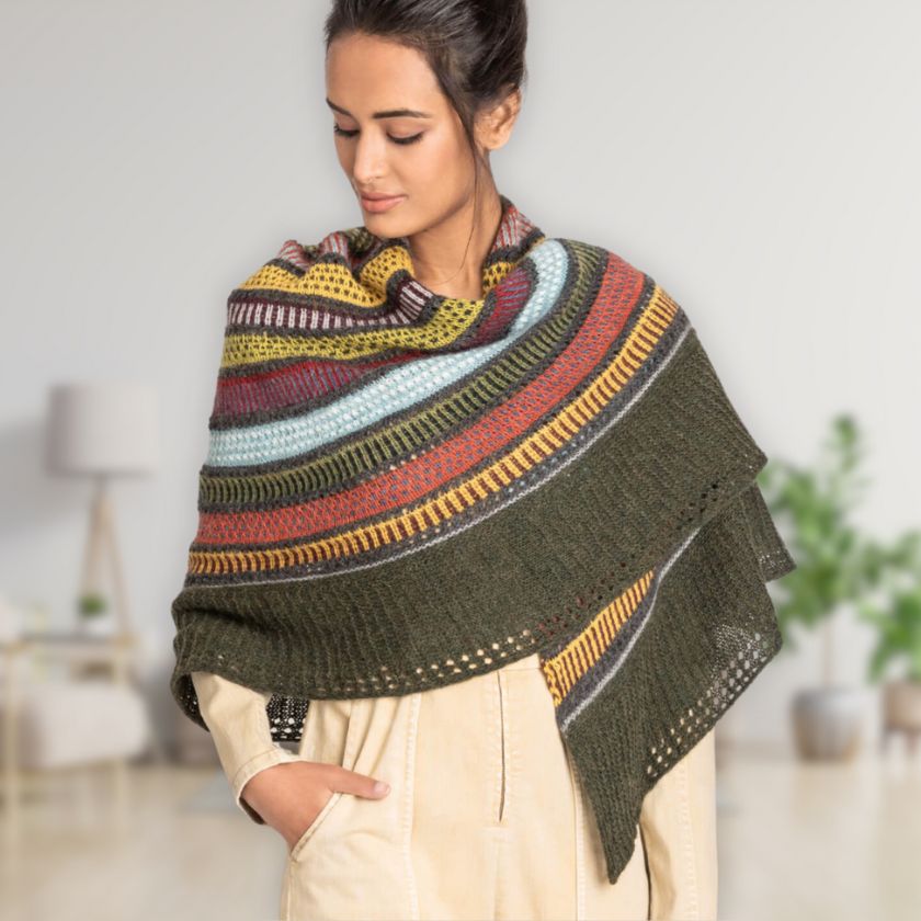 Model wears the 14 color Woolstok Light Shawl from the Dizzy Knitter