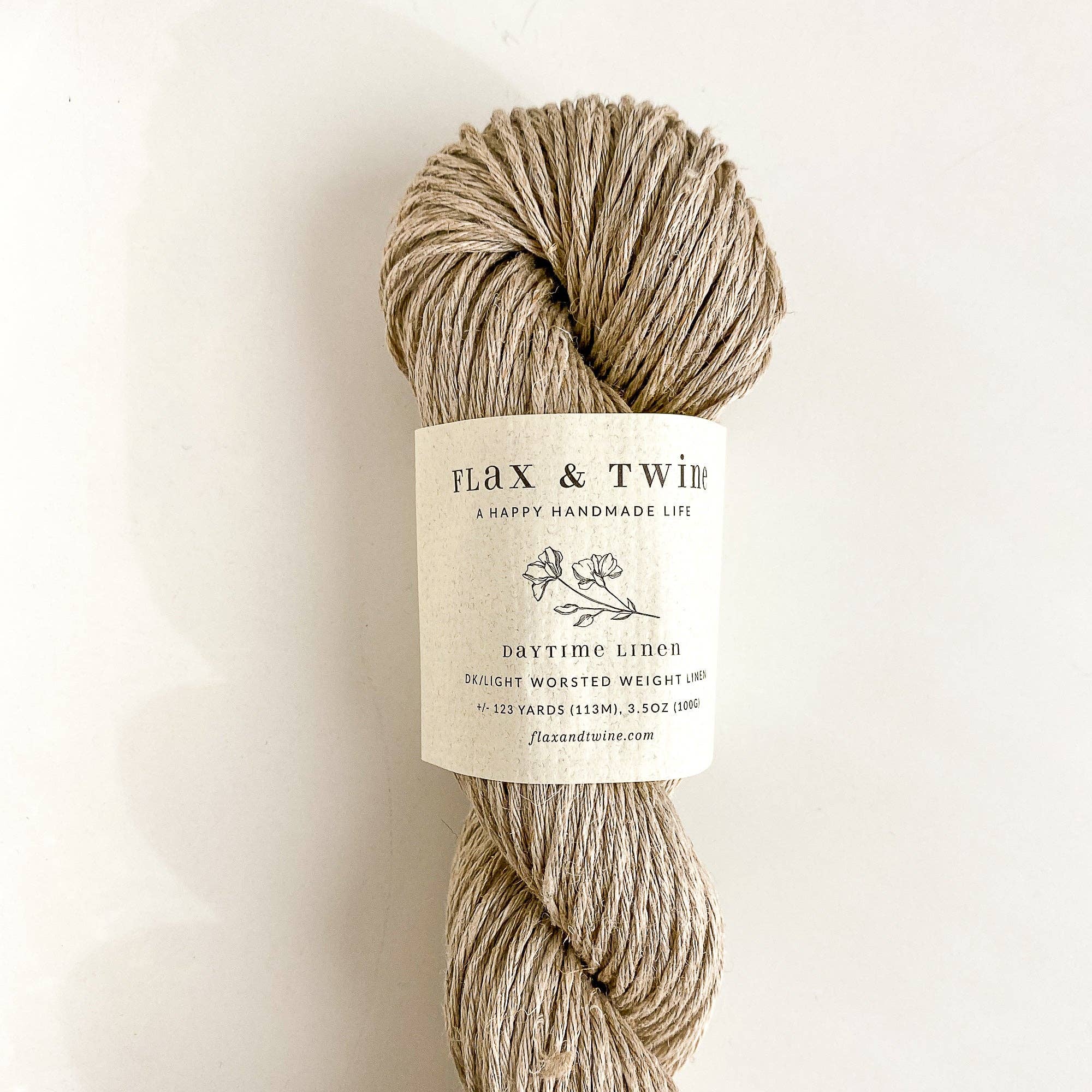 Ball of Flax & Twine Daytime Linen yarn with a label on a light background