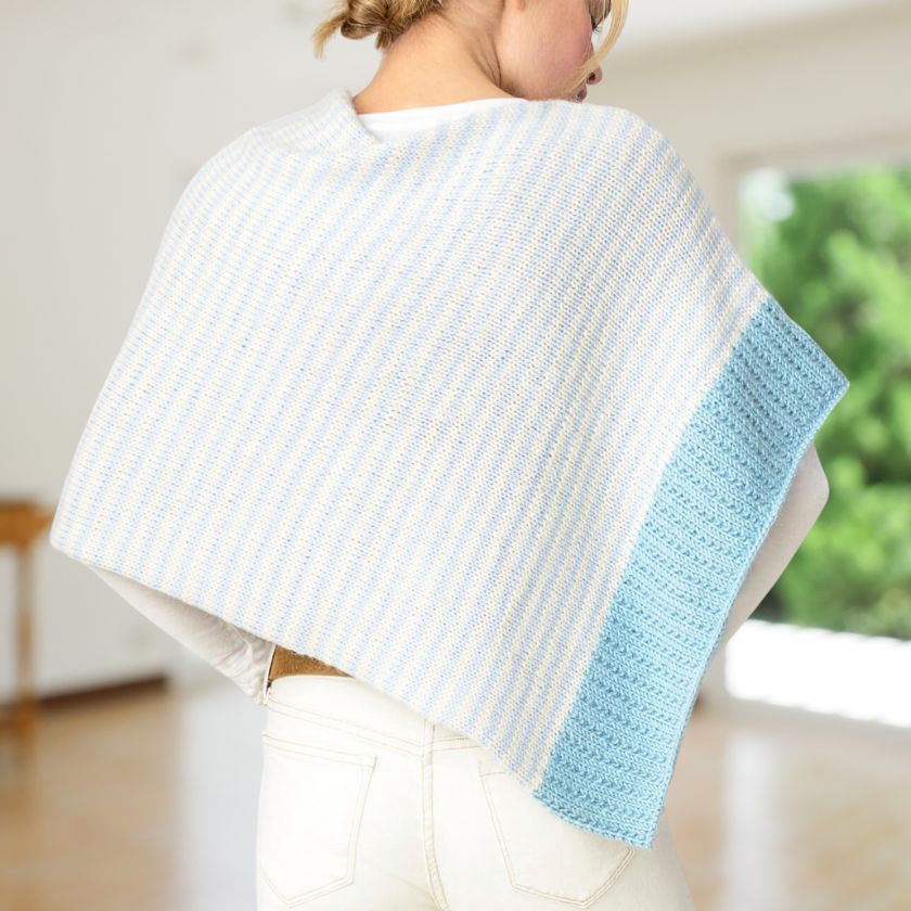 Woman showing the back view of the Winter Shoreline Bianca Wrap in an interior setting