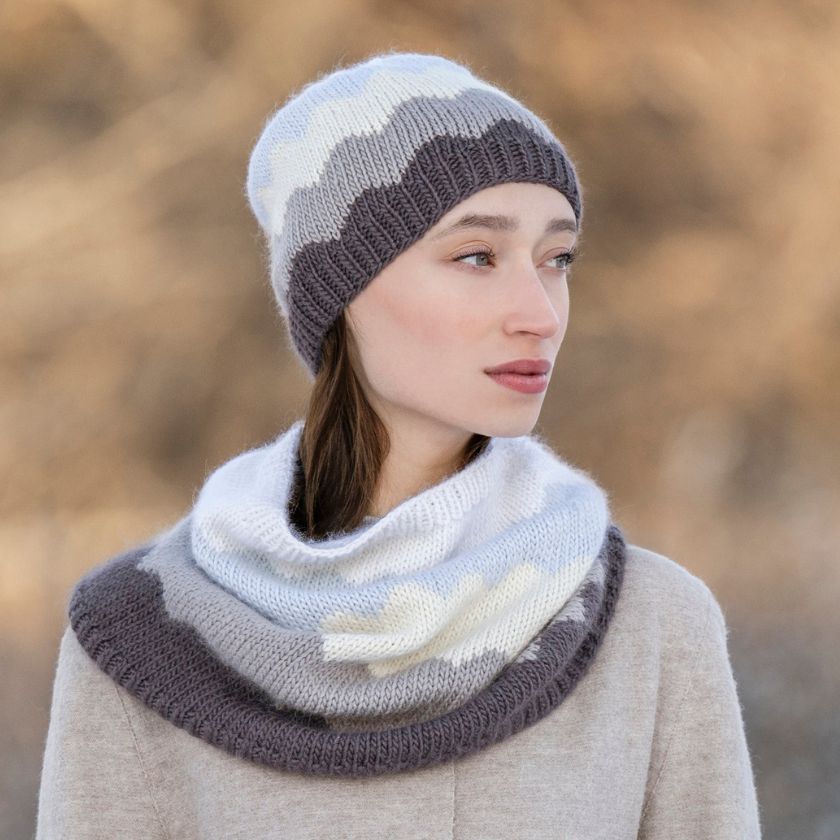 Woman wearing a Camino Cowl & Hat set against a blurred natural background