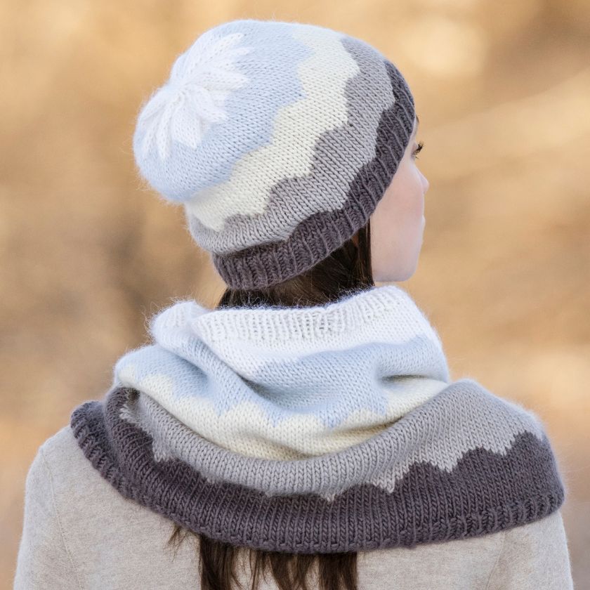 Person wearing a Camino Cowl and hat bundle against a blurred natural background