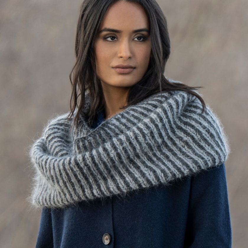 Model showcasing the Castle Rock Cowl from the Dizzy Knitter