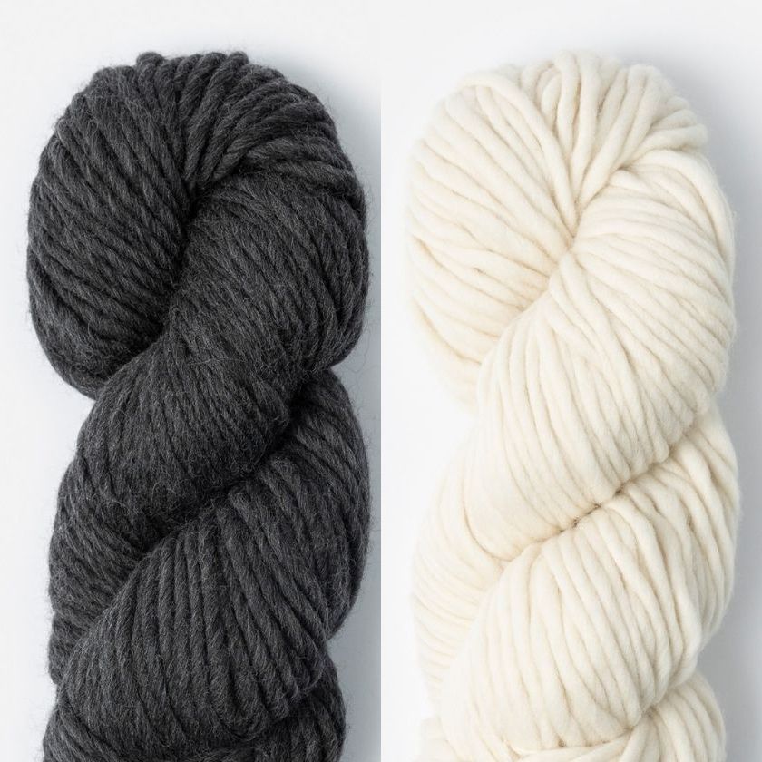 Two skeins of Woolstok North yarn in Cast Iron and Highland Fleece