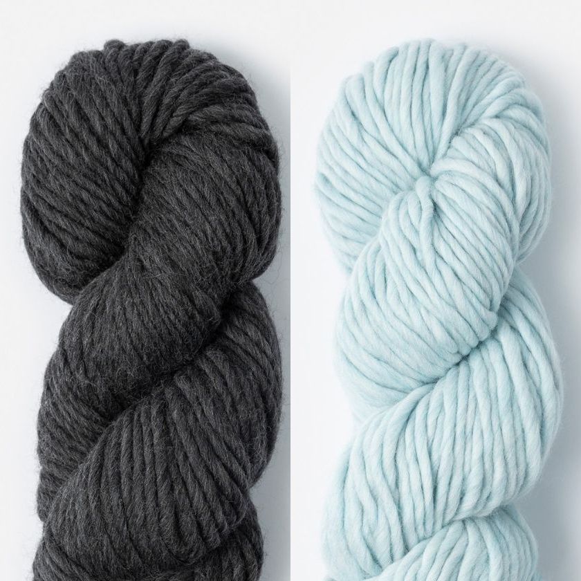 Two skeins of Woolstok North yarn in Cast Iron and Thermal Spring
