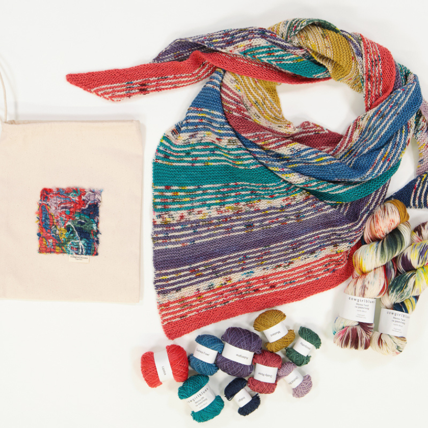 The completed I've Got Sushine Shawl kit with multiple skeins of yarn spread across a table