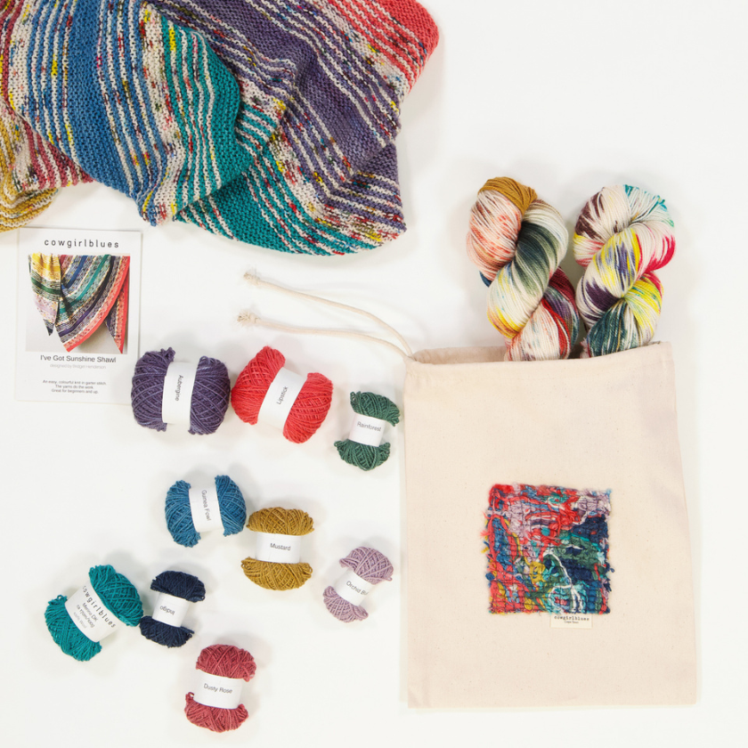 The I've Got Sushine Shawl kit with multiple skeins of yarn spread across a table