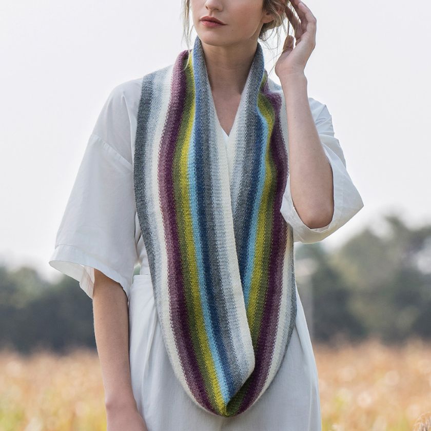 Model wears the Lighthouse Infinity Cowl from the Dizzy Knitter