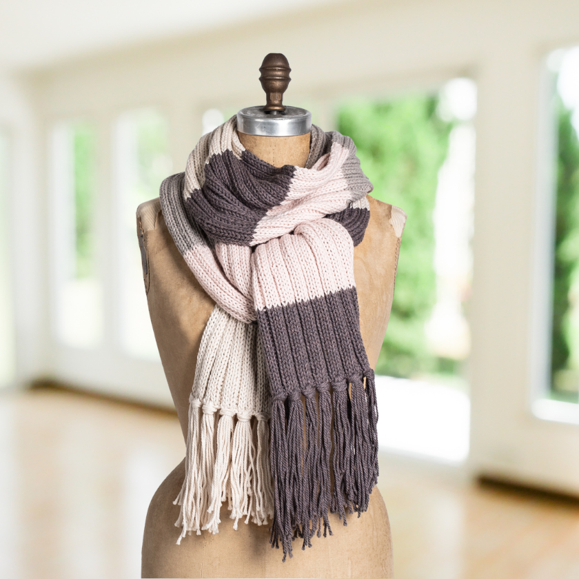 Close up of color block rib knit scarf in neutral tones with fringe, beginner-friendly knitting kit using soft wool cotton yarn
