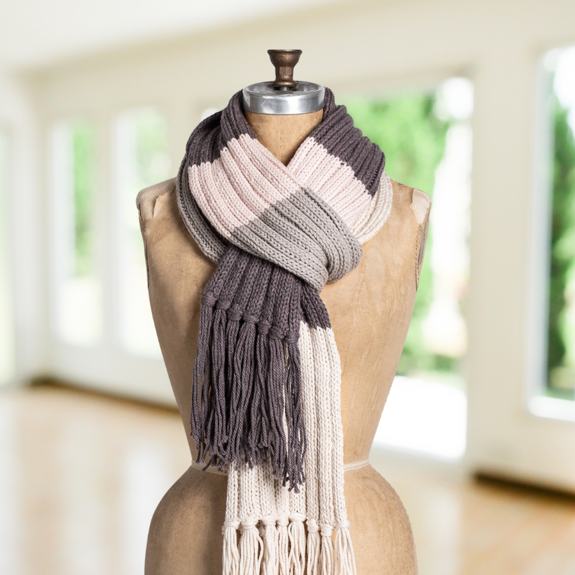 Color block rib knit scarf in neutral tones with fringe, beginner-friendly knitting kit using soft wool cotton yarn looped.