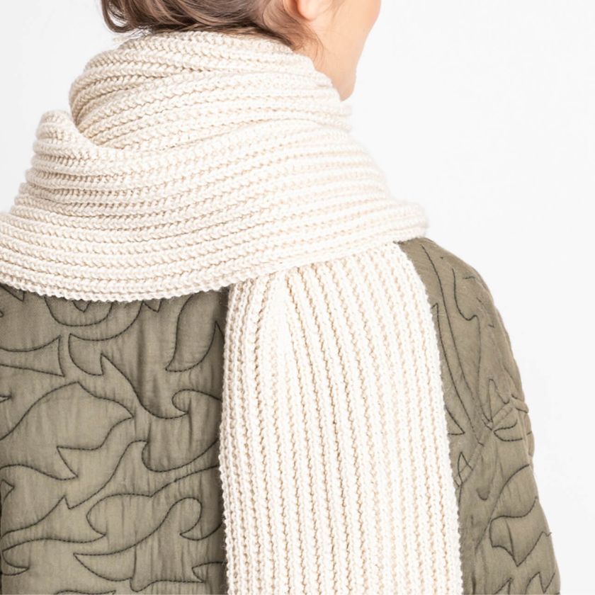 Back view of a model wearing the Winona Scarf from the Dizzy Knitter