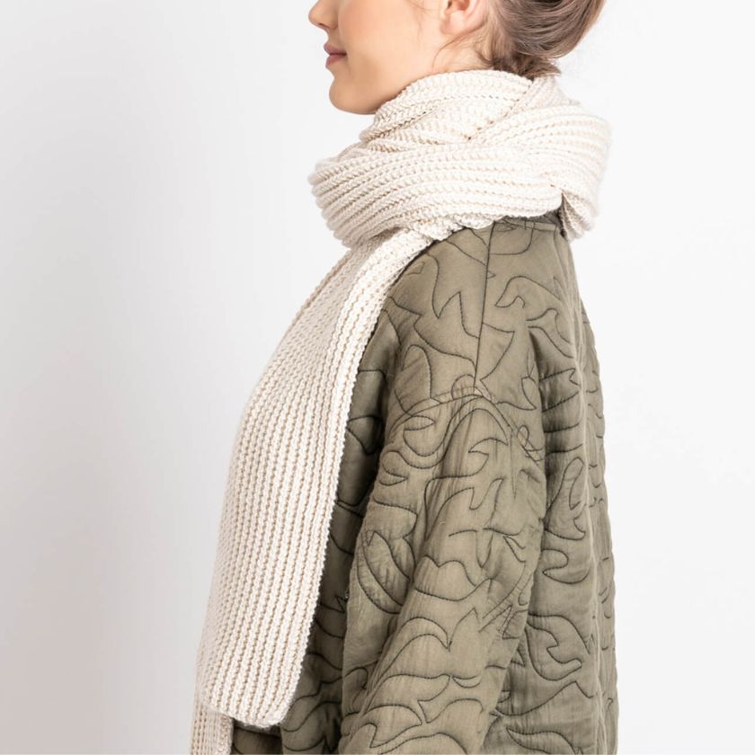 Side view of a model wearing the Winona Scarf from the Dizzy Knitter