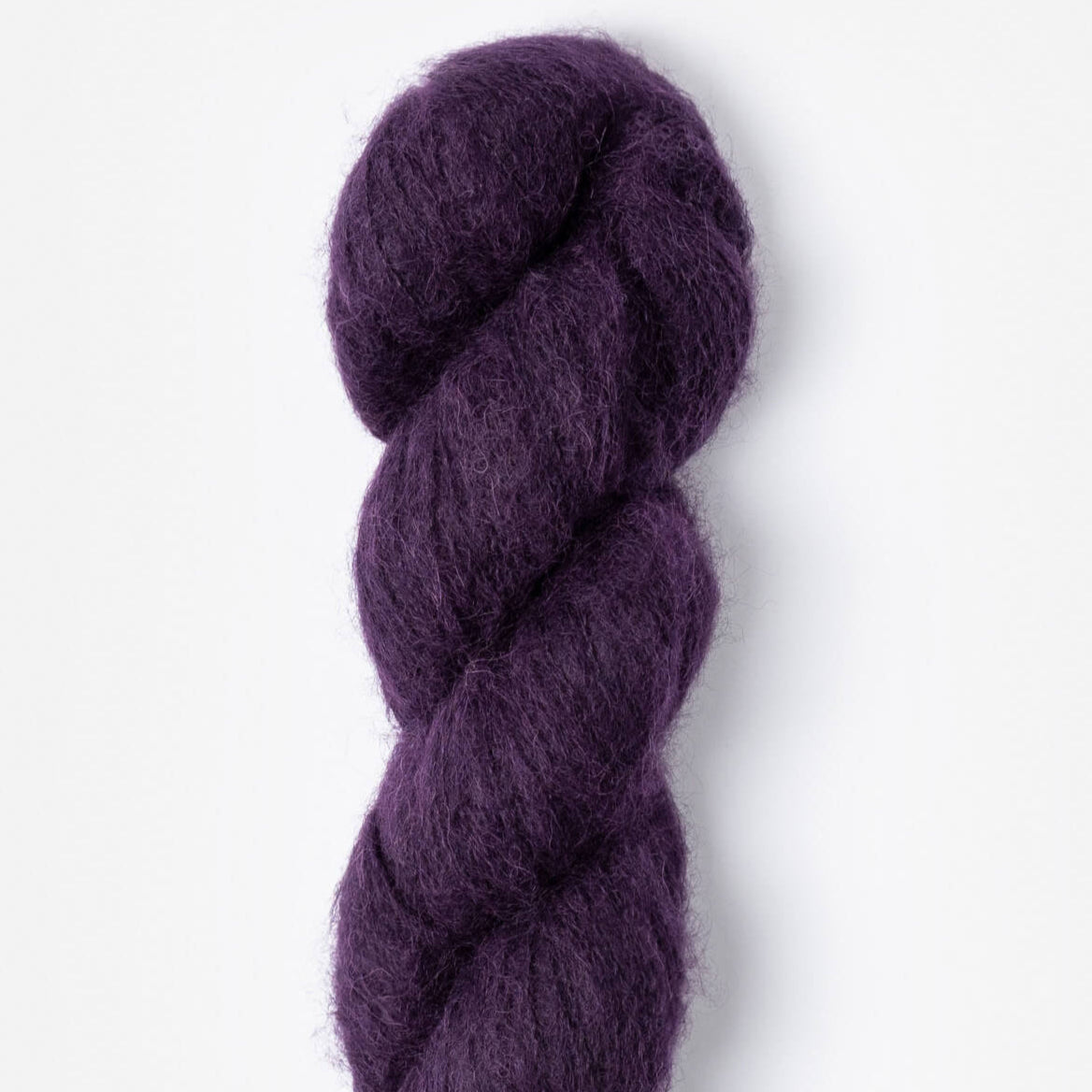 A skein of purple Elderberry Prairie, single-ply brushed suri yarn made from 100% alpaca fibers.