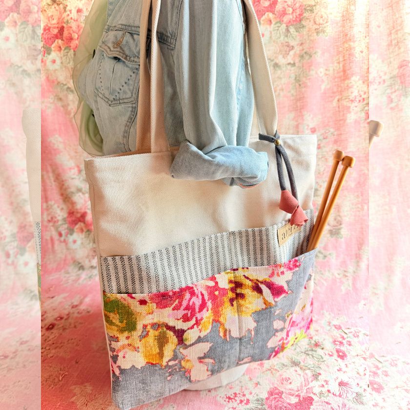 Floral atenti tote bag with denim jacket and knitting needles on a floral background