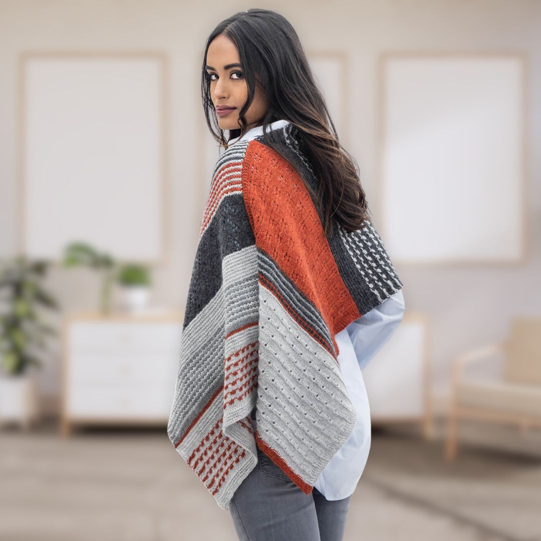 Model shows the back view of the Persimmon Wrap from the Dizzy Knitter