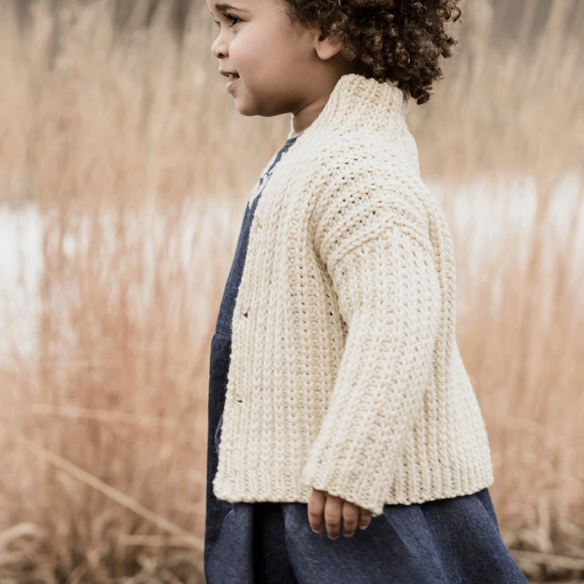 side view toddler wearing cream knit cardigan cookies and cream cardi textured sweater