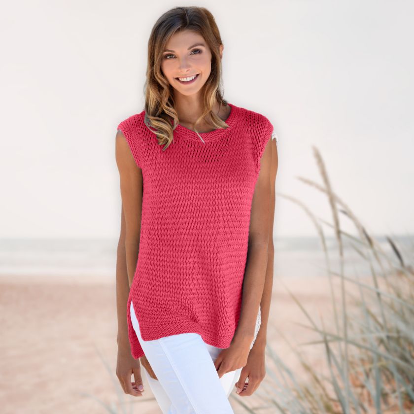 Model wearing the Dorothea Tank from the Dizzy Knitter in bing cherry yarn