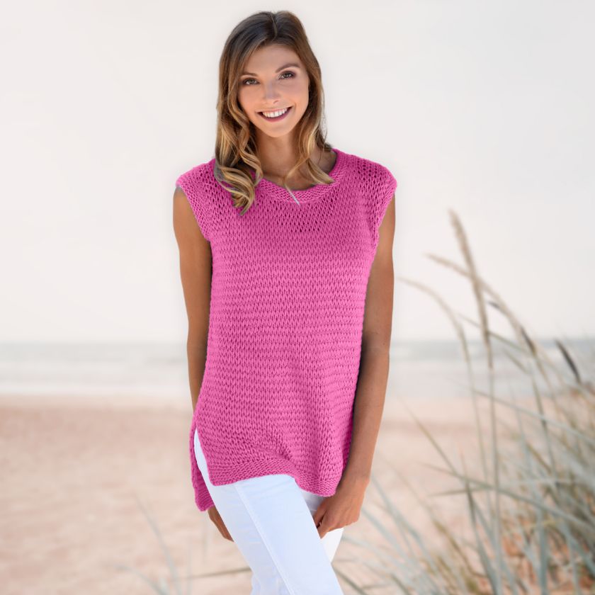 Model wearing the Dorothea Tank from the Dizzy Knitter in hollyhock