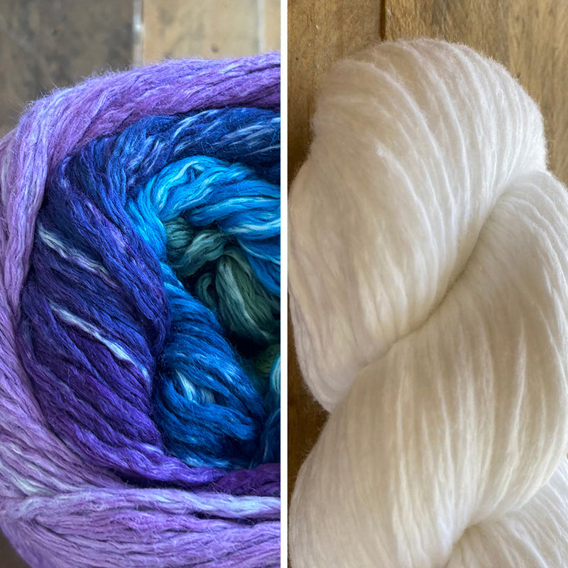 Two skeins of yarn, one Moonlight Jewel Cumulus Rainbow, the other Pearl Comulus Cotton, on a wooden surface.