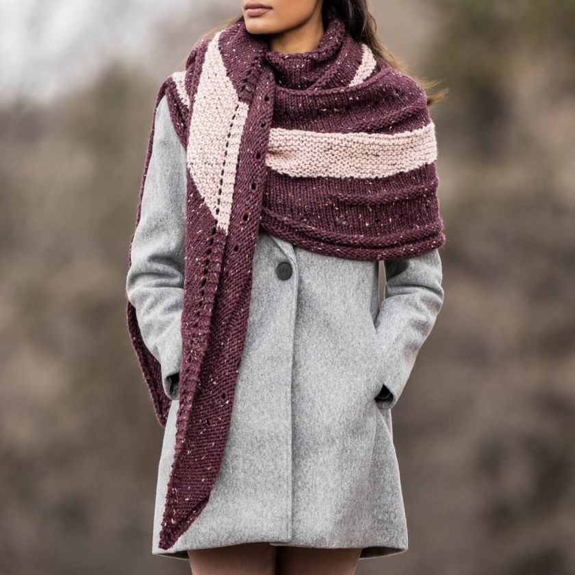 Front view of model wearing the Kelso Wrap with a cozy drape, highlighting textured bands and speckled tweed fabric.