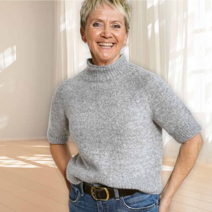 A model wearing the Kiara Knit Pullover from the Dizzy Knitter