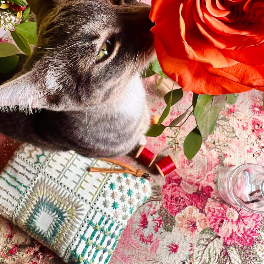 A knitting project pouch by Atenti bags with a cat smelling a flower