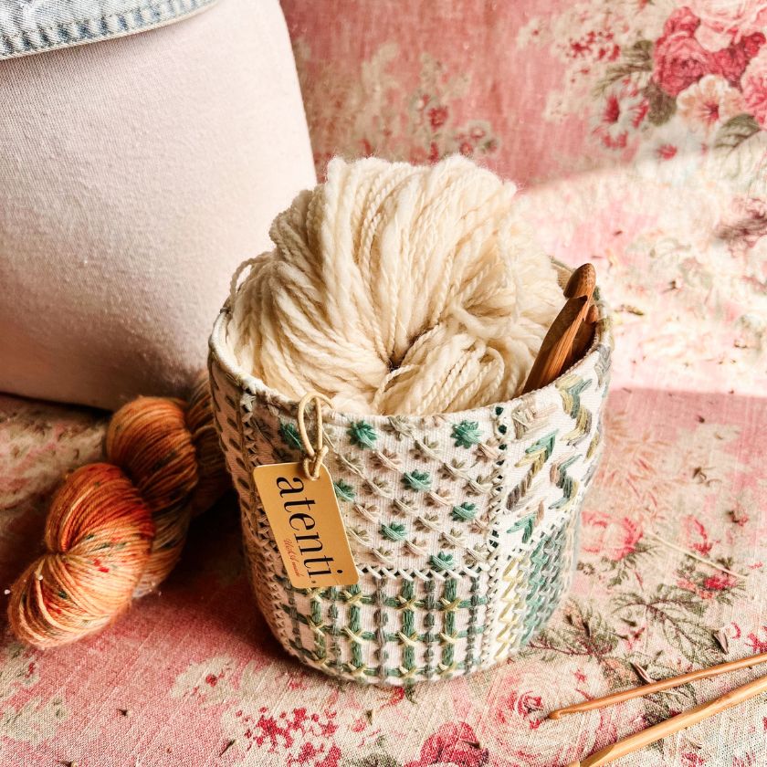 The Tiny Tucker fabric storage container with with yarns and knitting needles from Atenti bags