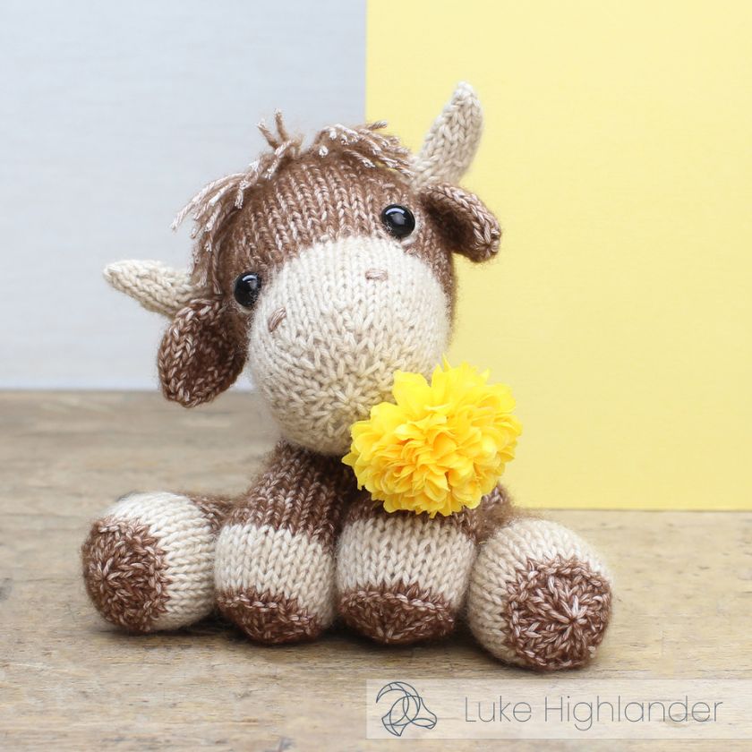 Amigurumi knitting kit of Luke Highlander wearing a yellow flower