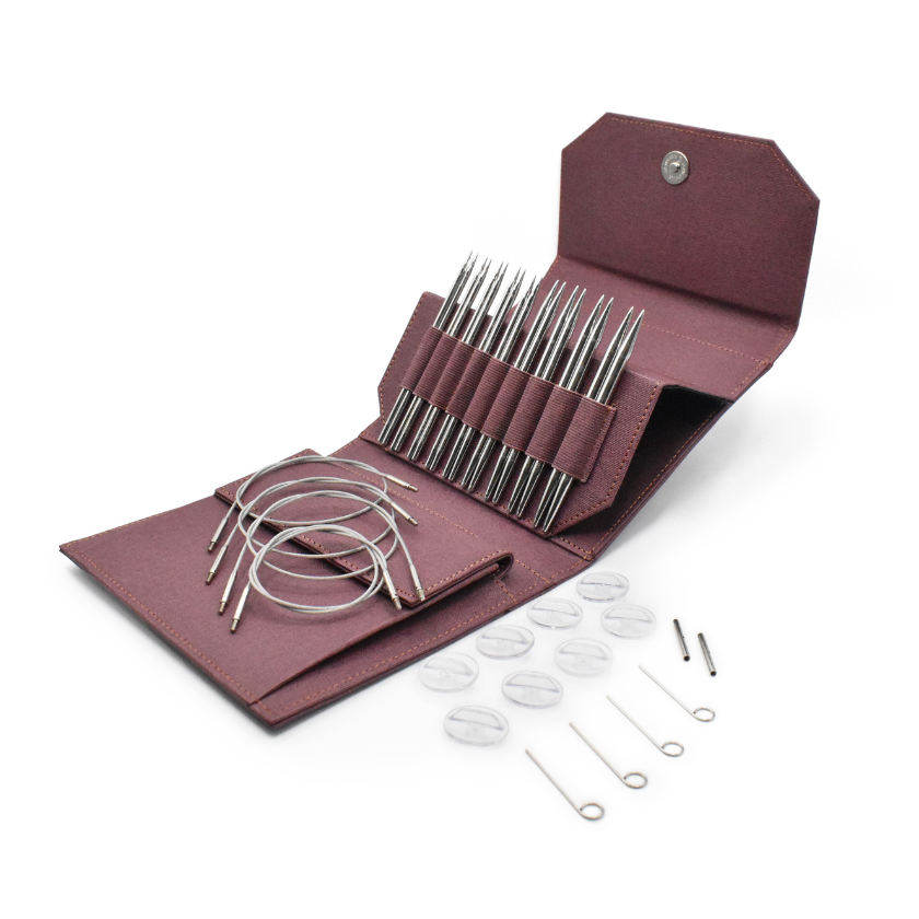 Set of Lykke metal knitting needles in various sizes with maroon case on a white background