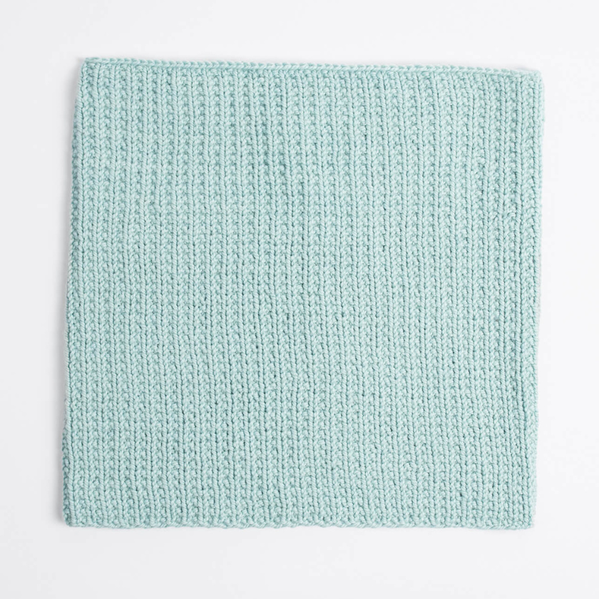 Mist Cowl knit in Blue Sky Fibers Extra Aran shown flat to display stitch texture and even fabric, The Dizzy Knitter