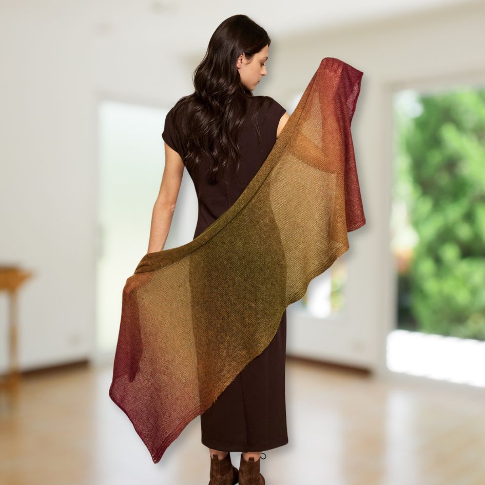Woman wearing a multicolored Poema Mohair wrap in a bright room