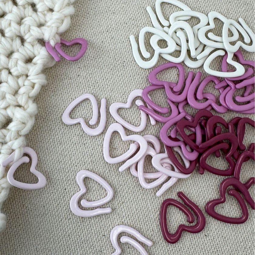 Heart shaped stitch markers with a visible colorfully coated metal from the Dizzy Knitter