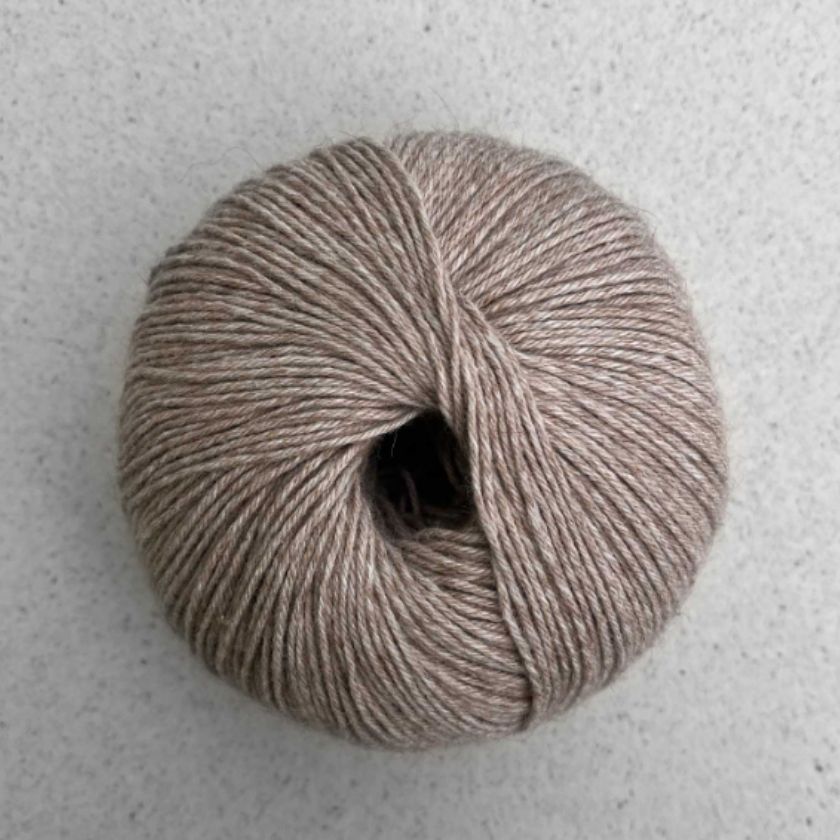 A ball of Walnut Puno yarn by Pascuali used in the Kiara tee kit from the Dizzy Knitter