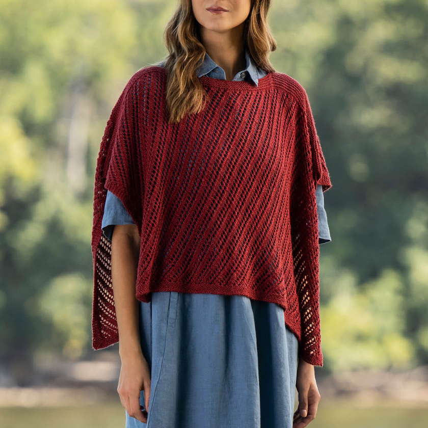 Ruby Wrap knitting kit shown from the front, styled over a blue dress with a soft draped fit.