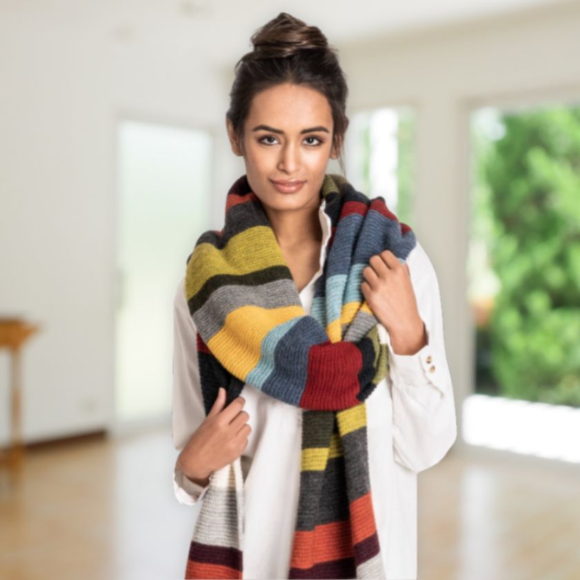 Model wears the 14 color Woolstok Light wrap from the Dizzy Knitter