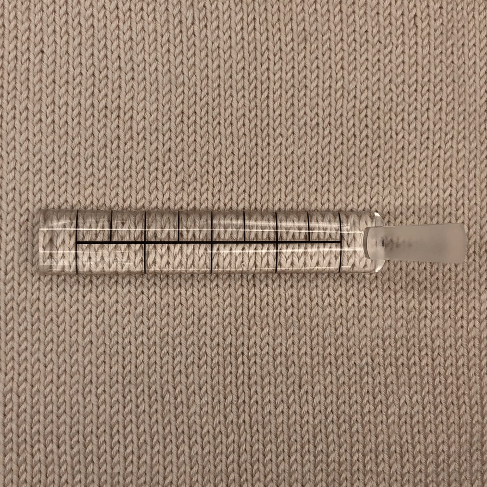 EZ Guage knitting accessory on a knitted fabric background