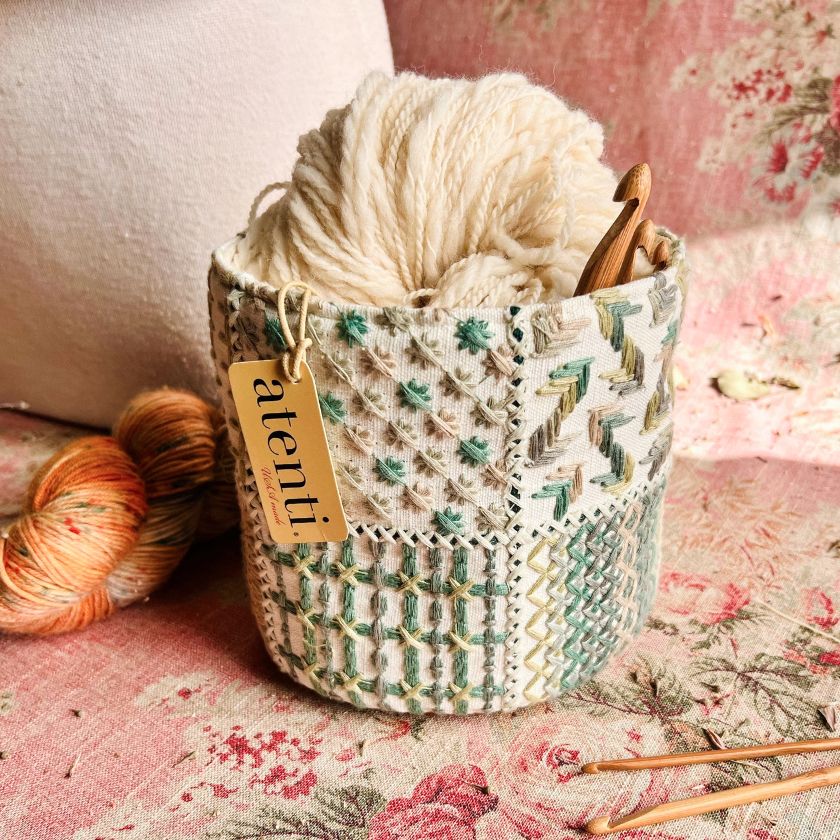 The Tiny Tucker fabric storage container with a floral mandala-like pattern in blue and gold colors, from Atenti bags