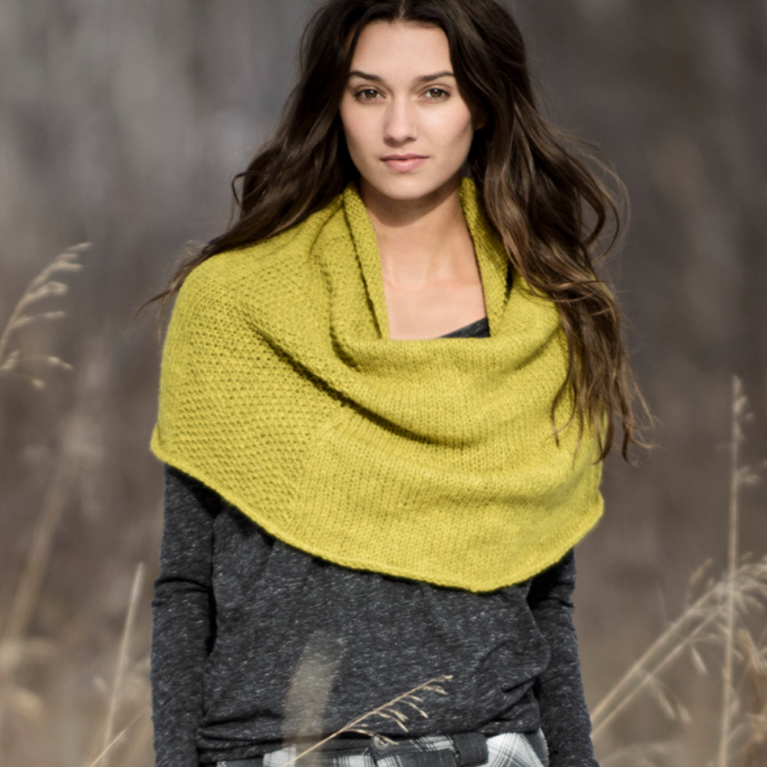 Trimont Snood worn hooded, showing soft knit texture and versatile drape in a natural setting