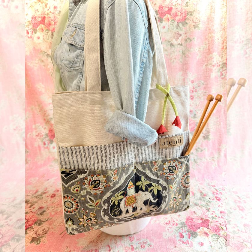 Trunks Tutto tote bag by Atenti with embroidered design and knitting needles on a floral background