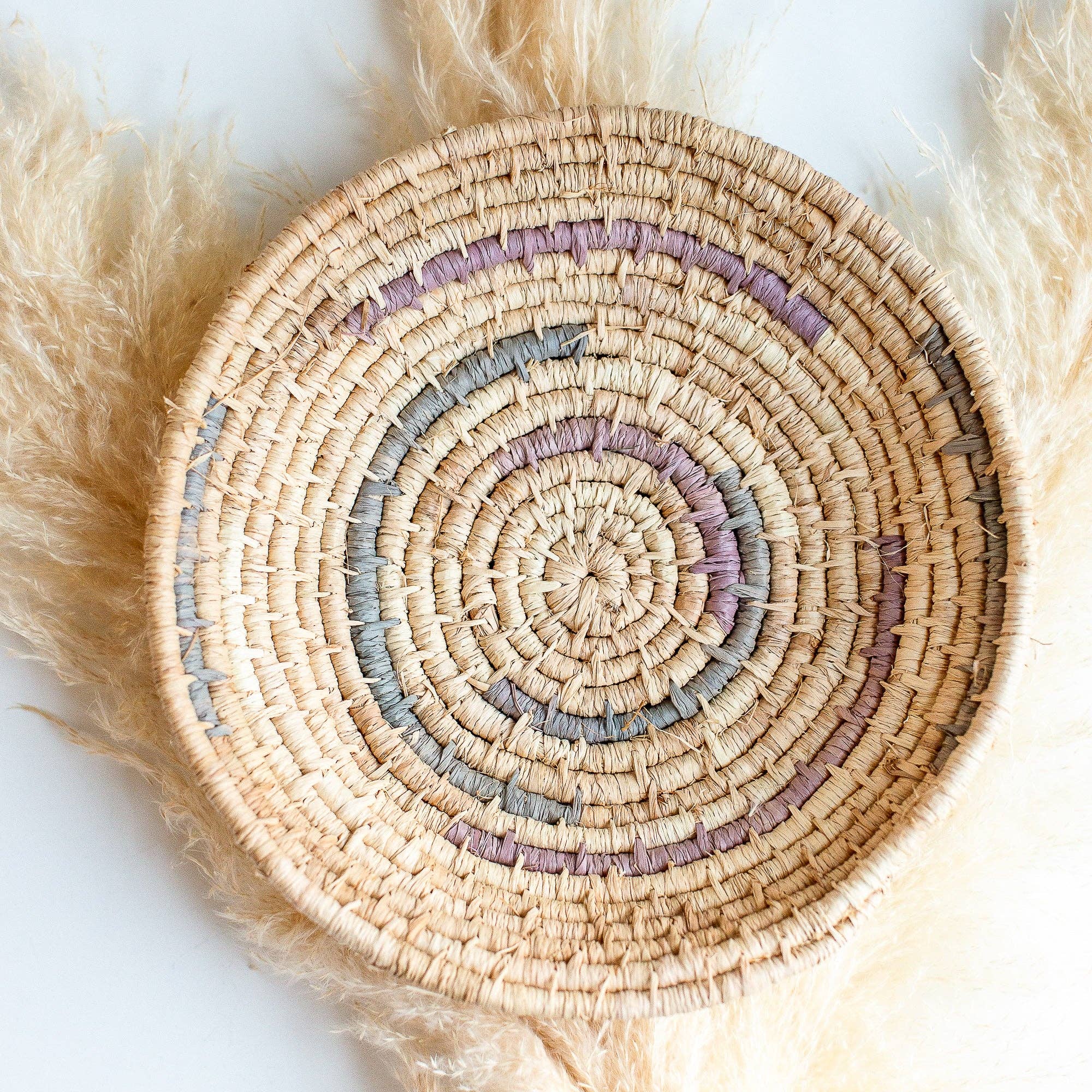 Woven Autumn Basket with concentric circles of different colors on a white background