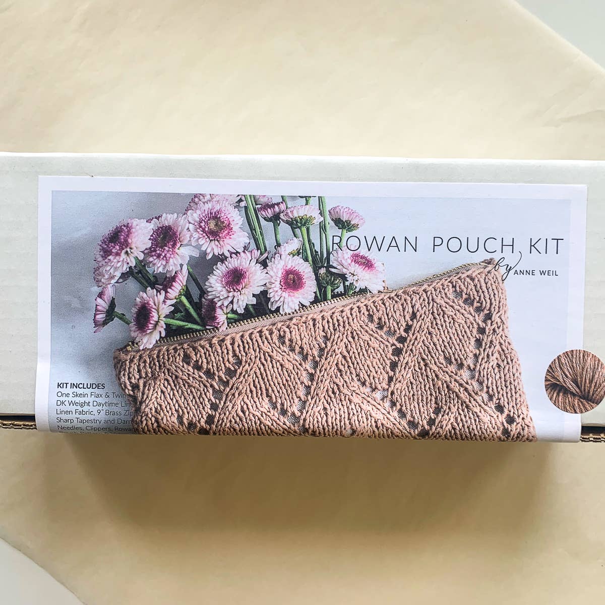 Rowan Pouch Kit packaging with a patterned pouch and flowers on a beige background