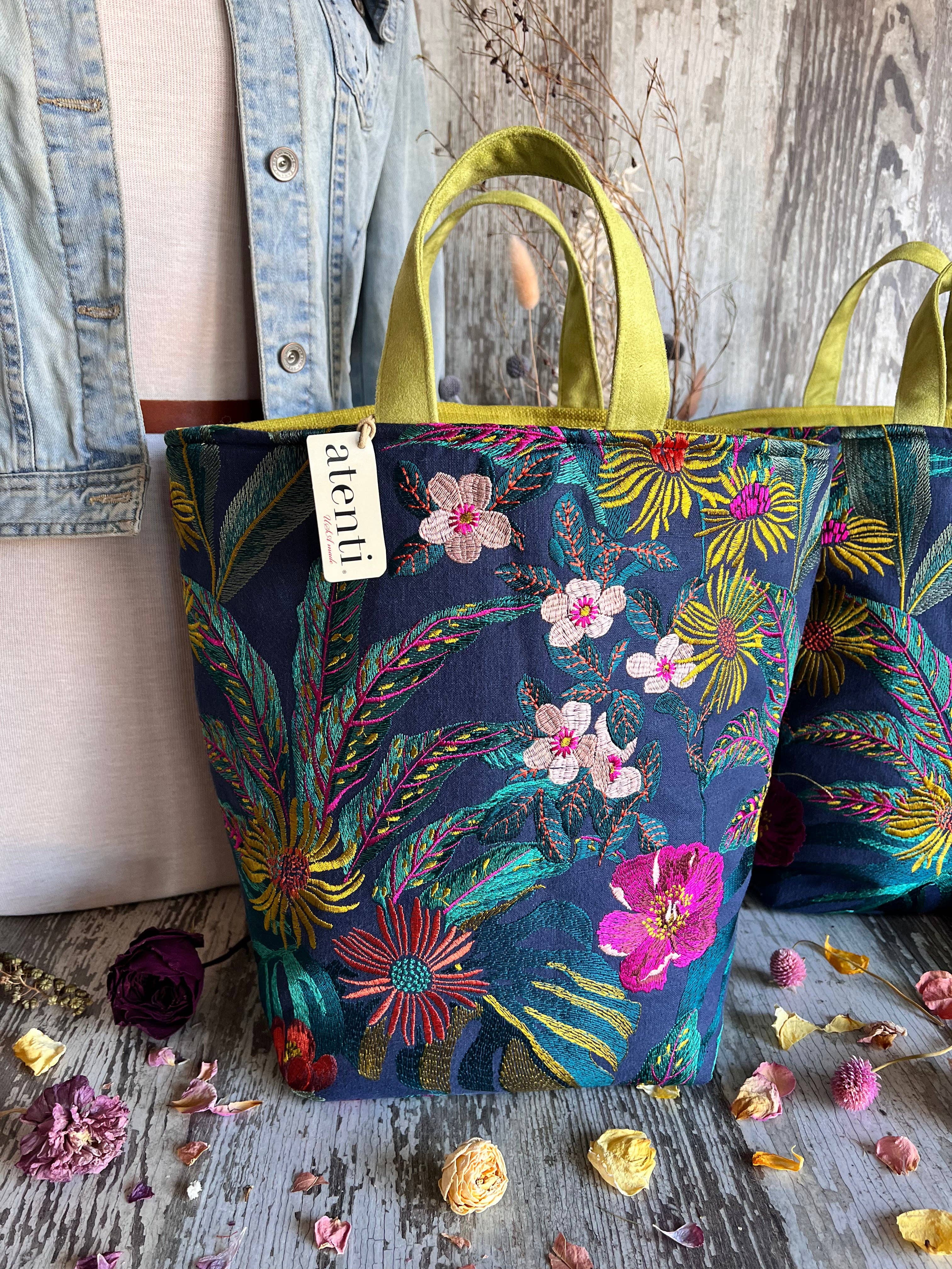 Floral tote bag by Atenti with colorful design on a wooden surface