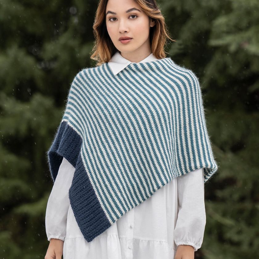 Woman wearing the Frozen Depths Bianca Wrap in a forest setting