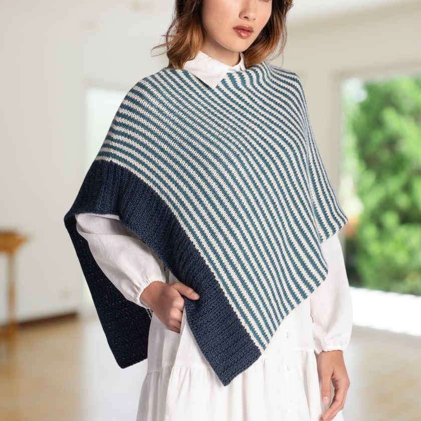 Model wearing a blue and white striped Bianca Wrap in a room setting