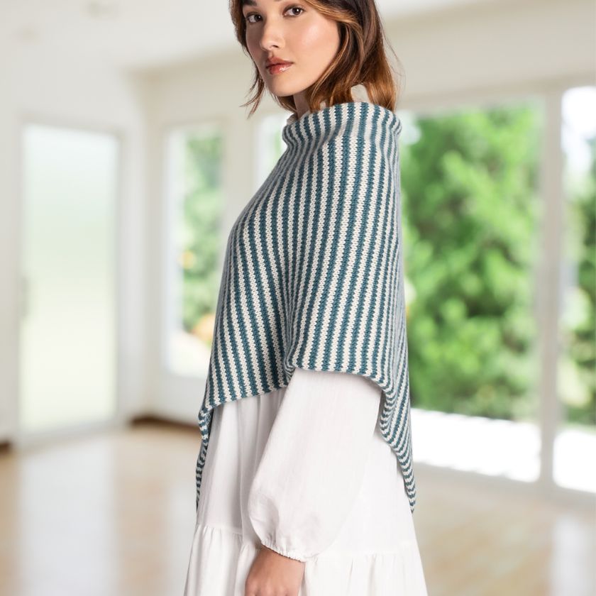 Model showcasing a side view of the Frozen Depths Bianca Wrap in a windowed room