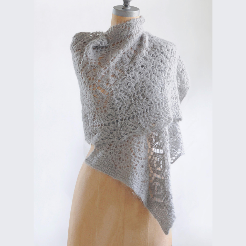 Gray knitted Brushed Suri shawl on a mannequin against a white background