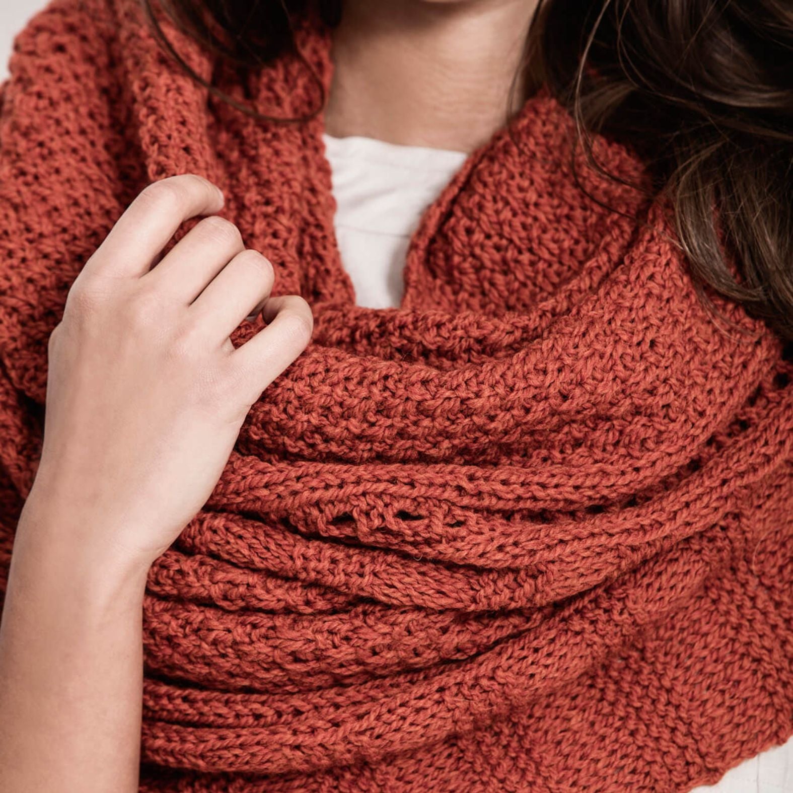 Close-up of the Endless Wrap knit scarf highlighting the textured knit and yarn-over stitch pattern in Woolstok worsted weight yarn.