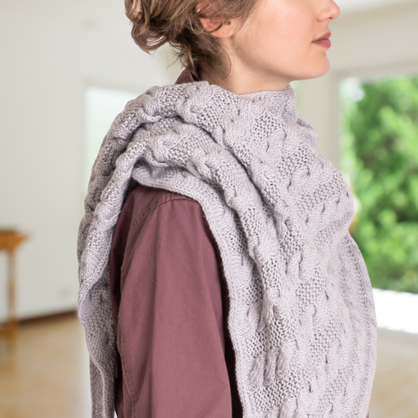 Model showcasing the textured Livonia shawl on a plain background