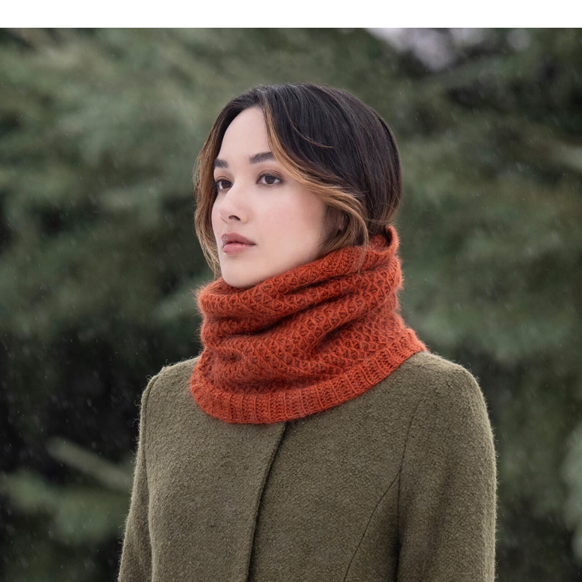 Side view of the Serene Sunset Cowl knit in Blue Sky Fibers Suri Merino in Autumn, highlighting the plush smock stitch texture and cozy fit. The Dizzy Knitter