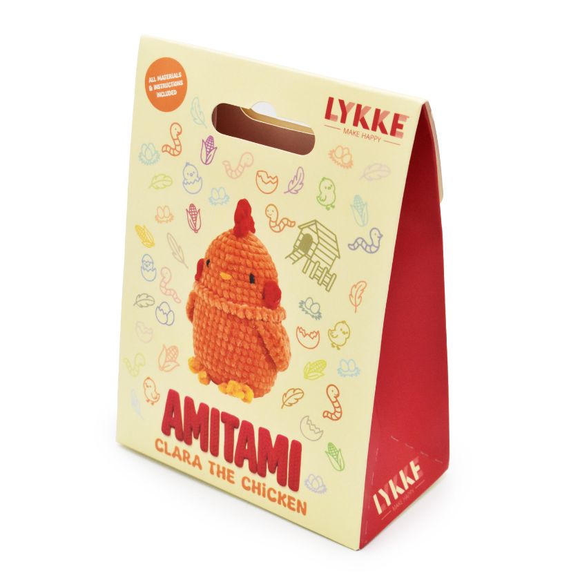 Packaging of an Amitami chicken knitting kit with 'LYKKE' branding on a white background
