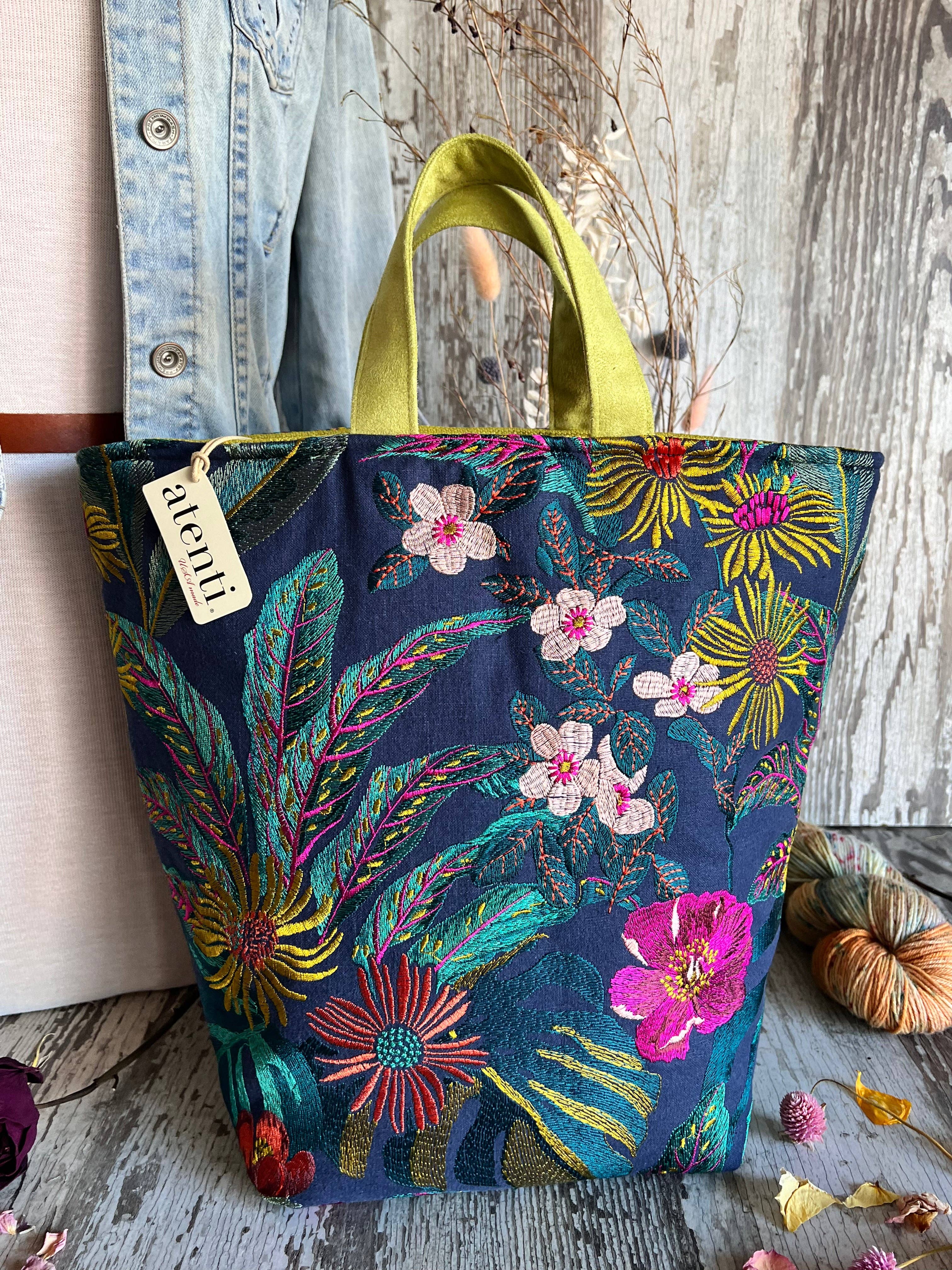 Floral patterned knitting tote by Atenti Bags with a visible brand tag on a wooden surface.
